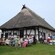 Guests dining at picnic tables near stables built in the Tudor style